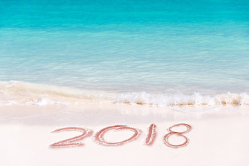 2018 written on the sand of a beach, travel 2018 new year concept