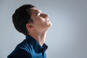 Relaxed male person raising his chin