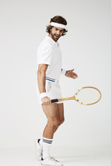 Tennis player playing in studio, looking down