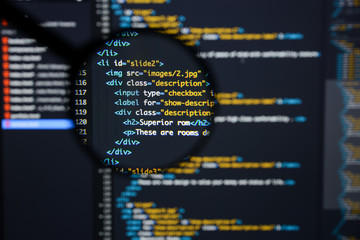 Real Html code developing screen. Programing workflow abstract algorithm concept. Lines of Html code visible under magnifying lens.