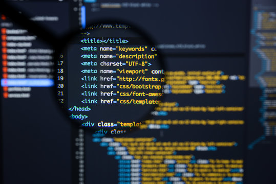 Real Html code developing screen. Programing workflow abstract algorithm concept. Lines of Html code visible under magnifying lens.