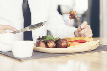 Beef Steak on wooden plate with woman hands.