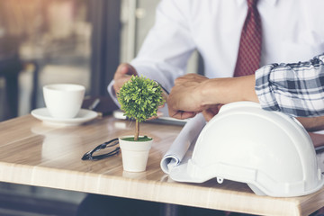 Smart Engineer and businessman discuss on project. Working Outdoor Team meeting. Safety white hard hat. Helmet safety equipment for industrial people.