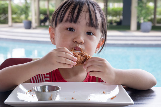 Asian Little Chinese Girl Eating Fried chicken