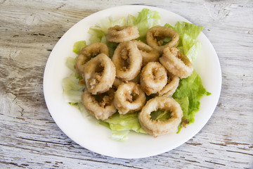 Fried calamari served on a plate.