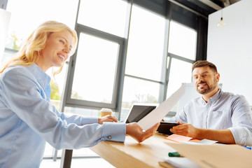 Delighted woman examining important document