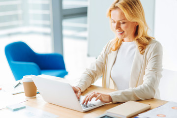 Portrait of smiling woman that working with laptop