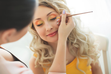 Obraz premium A woman doing makeup 