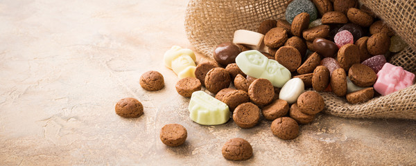 Burlap sack with traditional sweets for the Dutch holiday 'Sinterklaas'. Festive concept with copy...