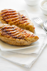 Grilled chicken breast on white table cloth