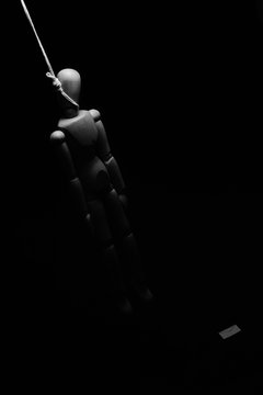hang man figure and suicide letter on black background.