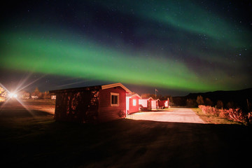 Beautiful picture of massive multicolored green vibrant Aurora Borealis, Aurora Polaris, also know as Northern Lights in the night sky over Norway, Scandinavia