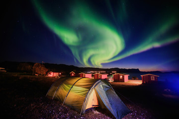 Beautiful picture of massive multicolored green vibrant Aurora Borealis, Aurora Polaris, also know as Northern Lights in the night sky over Norway, Scandinavia