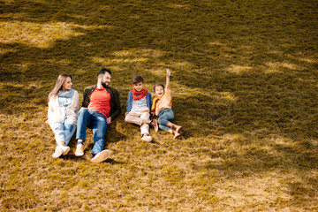 family relaxing on lawn