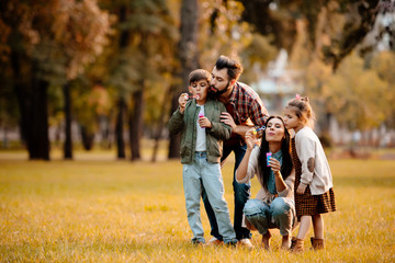Fototapeta premium Parents with children blowing bubbles