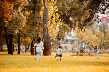 Family playing with kite in park