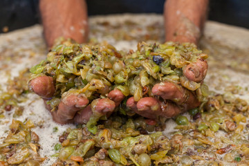 Farmer hands keep grape must
