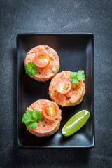 Tasty salmon tartare with lime and cherry tomatoes