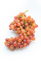 Ripe red grape. Pink bunch isolated on white.