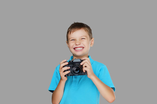 A boy taking pictures with a professional camera.