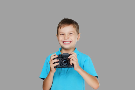 A boy taking pictures with a professional camera.