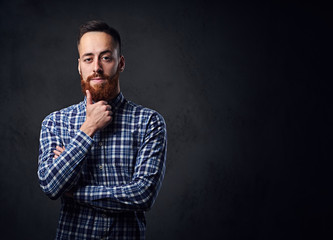 Fototapeta premium A man with crossed arms, dressed in a blue fleece shirt.