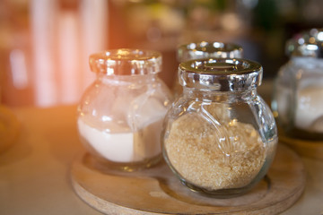The set bottle of brown sugar in cafe.