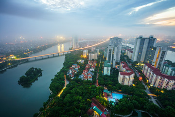 Fototapeta na wymiar Aerial skyline view of Hanoi cityscape at dawn with low clouds. Linh Dam peninsula, Hoang Mai district.