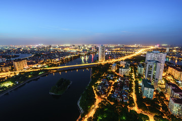 Obraz na płótnie Canvas Aerial skyline view of Hanoi cityscape at twilight. Linh Dam peninsula, Hoang Mai district, Hanoi, Vietnam