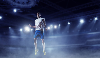 Soccer player at stadium. Mixed media