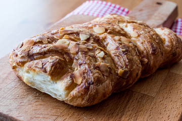 Almond Croissant on wooden surface.