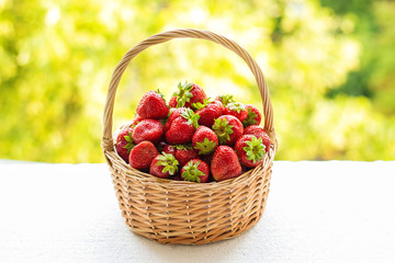 Strawberries in a basket. Strawberries in a basket. Vegetable garden, fruit. Red strawberry on the green background.