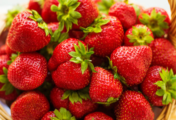 Fototapeta na wymiar Strawberries in a basket. Garden, vegetable, fruit. Red strawberry on the green background.