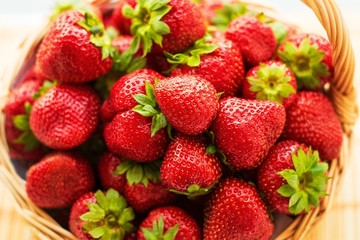 Strawberries in a basket. Garden, vegetable, fruit. Red strawberry on the green background.
