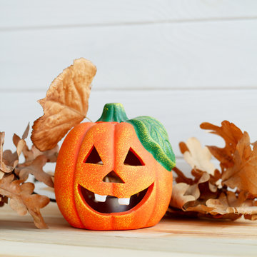 Picture of pumpkie over white wooden background. Halloween concept.