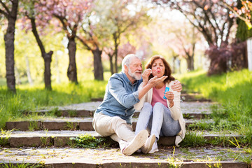 Beautiful senior couple in love outside in spring nature.