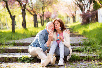 Beautiful senior couple in love outside in spring nature.