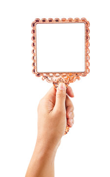 Beautiful vintage mirror for makeup in woman hand.