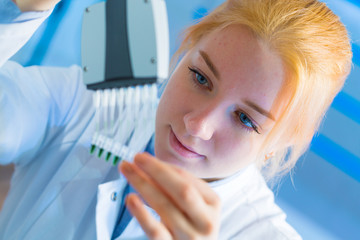 Woman student with pcr devices in medical laboratory