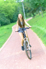 Naklejka premium Girl teenager on a bicycle