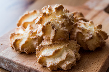 Coconut Cookies on wooden surface.