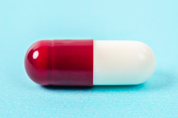 Red and white pills capsule.
