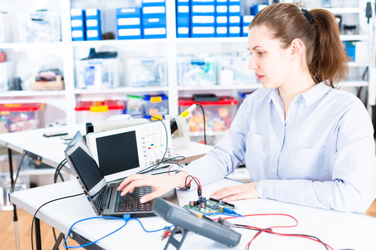 Young woman in electronics repair service center