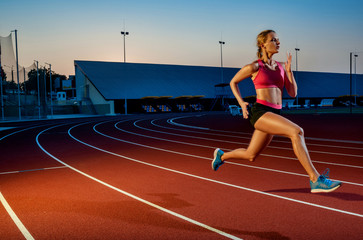 Runner sprinting towards success on run path running athletic track. Goal achievement concept.