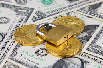 Physical version of Bitcoin (new virtual money) and golden padlock. Conceptual image for money and...