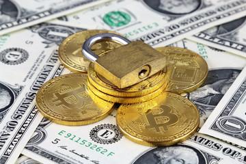 Physical version of Bitcoin (new virtual money) and golden padlock. Conceptual image for money and...