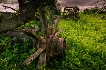 A old wagon lies derelict in the field on a farm 