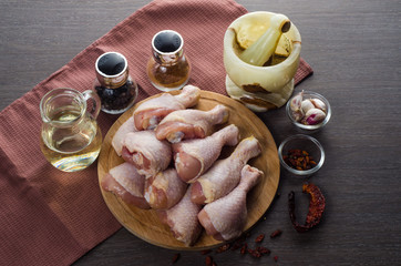 Fresh raw chicken legs arrangement on kitchen cutting board