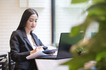 Fototapeta premium Beautiful Asian Woman using Laptop for Work at cafe, Attractive Woman work at office Concept.