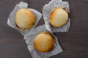 Close-up of home made burgers on wooden background
